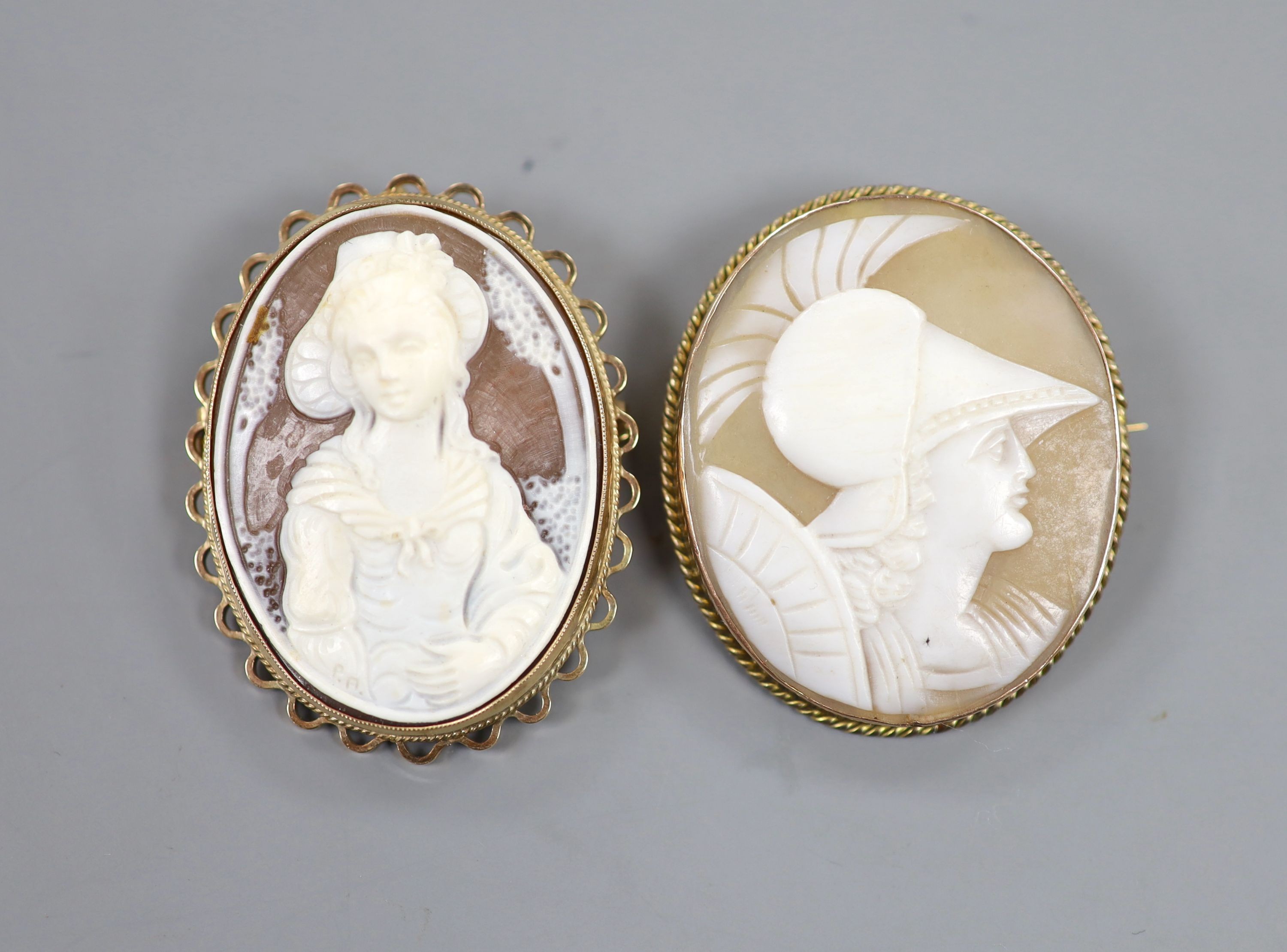 Two 9ct mounted oval cameo shell brooches, one with pendant mount, largest 44mm, gross weight 20 grams.